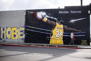 January 22, 2021, North Hollywood, California, USA: A woman passes a Kobe Bryant mural by Bandi Tart on the wall of Varouj Appliances in North Hollywood on Friday, January 22, 2021.