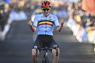 Belgian Remco Evenepoel celebrates as he crosses the finish line to win the men's elite road race at the UCI Road World Championships Cycling 2022, in Wollongong, Australia