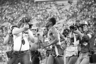 Photo correspondents surround Ethiopian athlete Miruts Yifter, who won the 10,000-meter run during the Twenty-Second Summer Olympics in Moscow.
